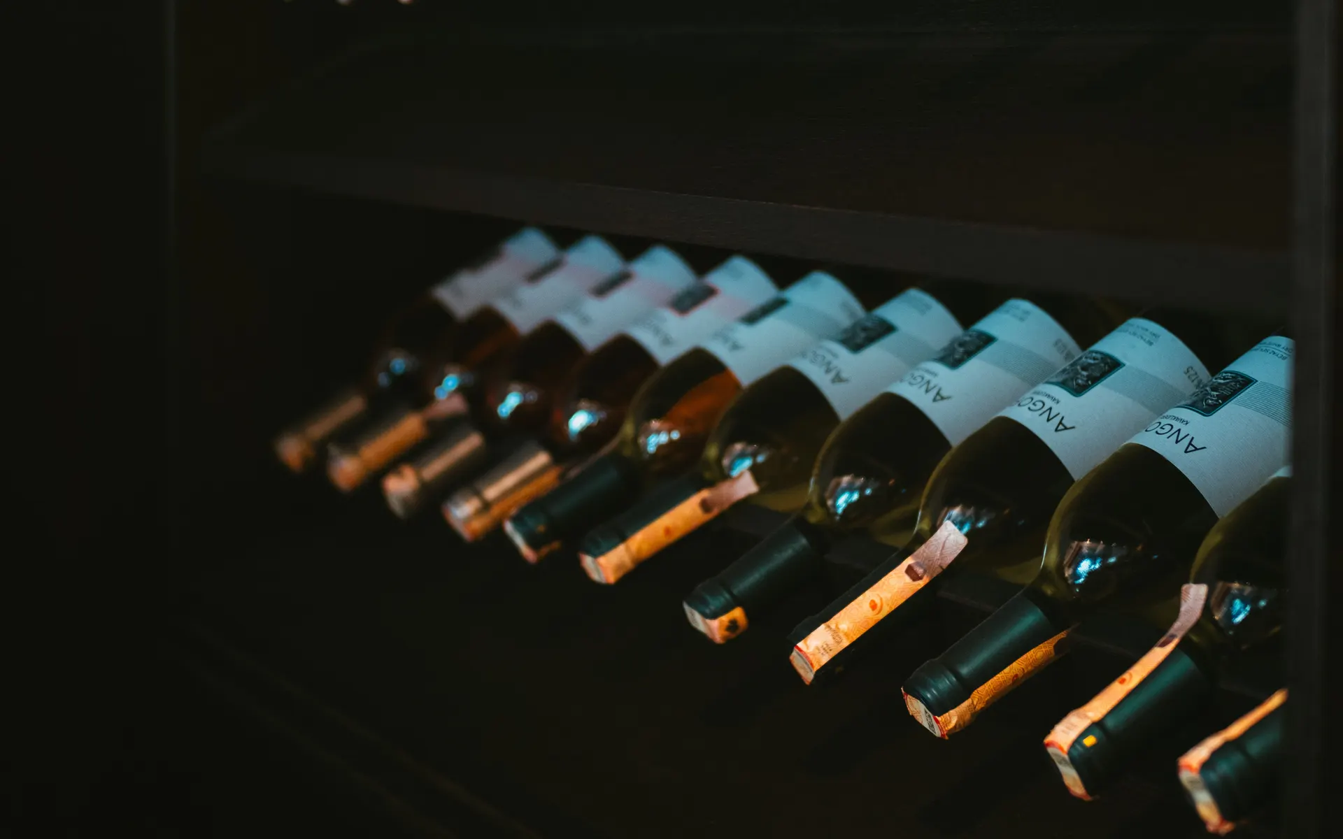 Aged And Amber Napa Valley spirits cellar with rows of bottles resting in a climate-controlled rack